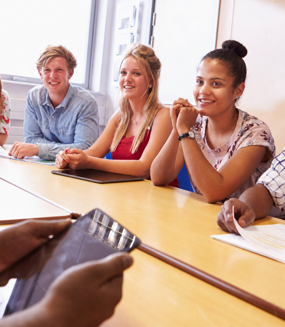 Students participating in a teacher-led classroom discussion